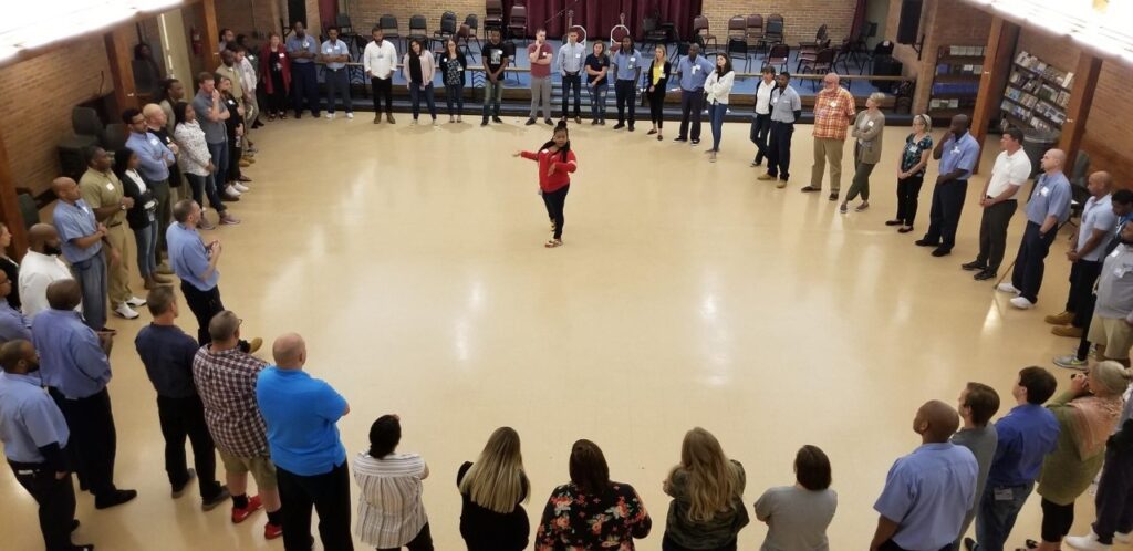 Photo of people standing in a circle