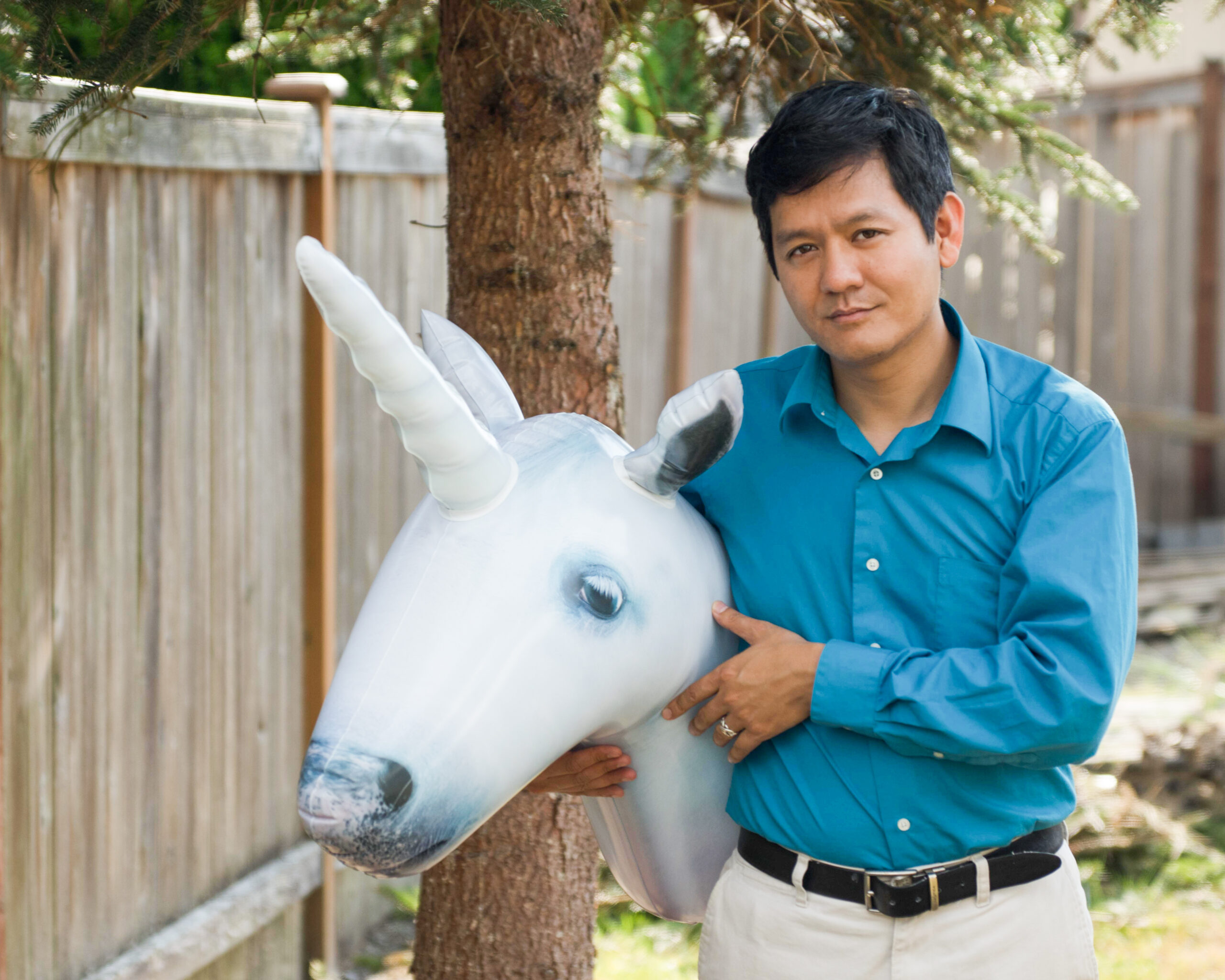 Photo of nonprofit executive and author of Nonprofit AF, Vu Le, holding an inflatable unicorn